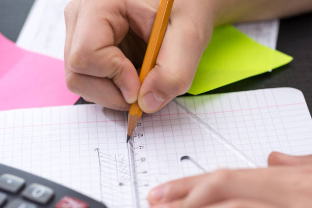istock Schoolboy Hands with Ruler Drawing on Paper. Mathematics Concept. 1149304979