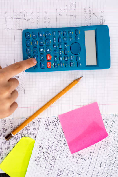 istock Scientific Calculator in the Action Hands During Mathematical Lesson. School Concept. 1149305340