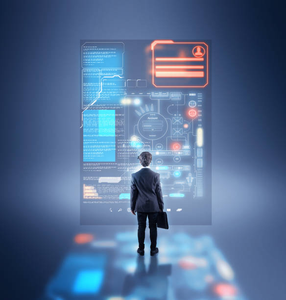 Businessman standing in front of futuristic user interface. stock photo