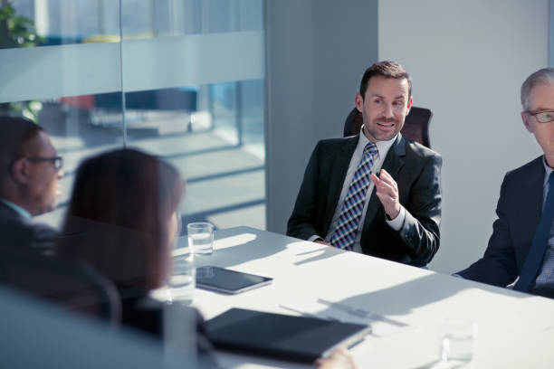 istock Businessman talking with colleagues in meeting 1149305814