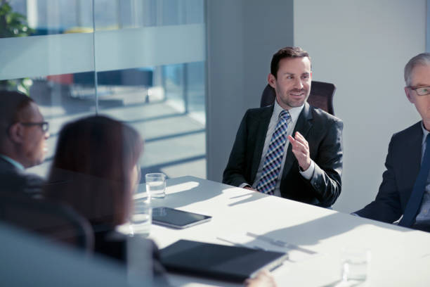 istock Businessman talking with colleagues in meeting 1149306331