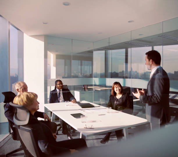 istock Businessman talking with colleagues in modern office meeting 1149306435