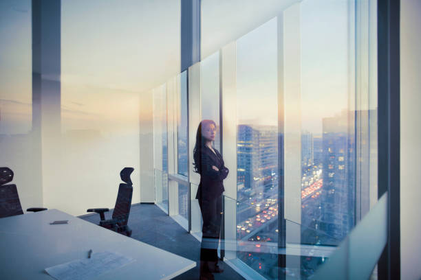 Portrait of Businesswoman looking at camera in meeting room Adult Hispanic woman CEO executive businesswoman business person in conference meeting room in contemporary modern office daylight sunset dusk talking planning thinking strategy well dressed suit diversity multi-ethnic problems solutions unity cityscape downtown urban new beginnings breaking new ground decisions choices the way forward contemplation vision focus choices decisions solitude quiet alone the bigger picture stock pictures, royalty-free photos & images