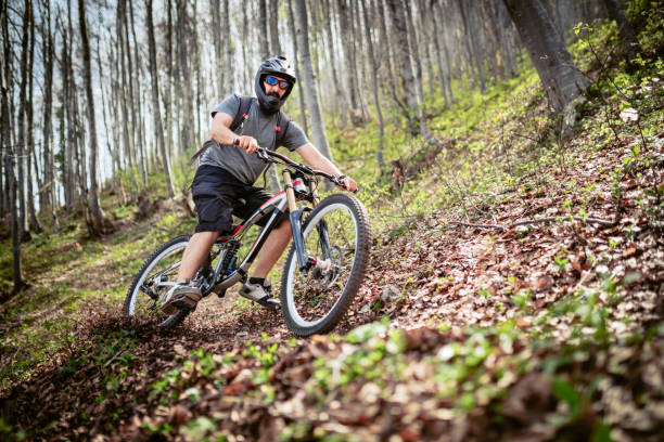 istock Biker moving down the forest - downhill cycling 1149309566