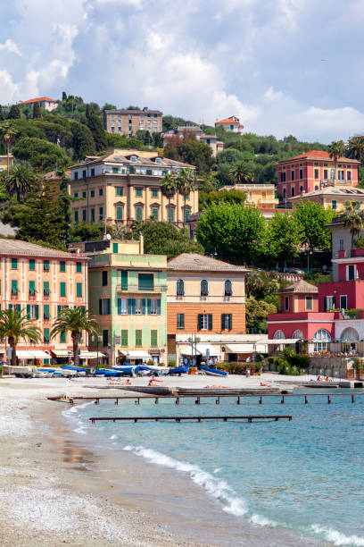 Sunning on the Beach next to restaurants and hotels in Santa Margherita Ligure Sunning on the Beach next to restaurants and hotels in Santa Margherita Ligure santa margherita ligure italy stock pictures, royalty-free photos & images