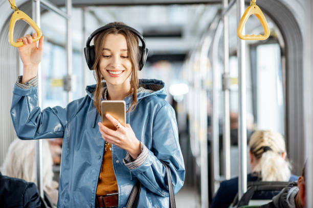 公共交通機関を利用した女性旅客 - bus inside of people train ストックフォトと画像