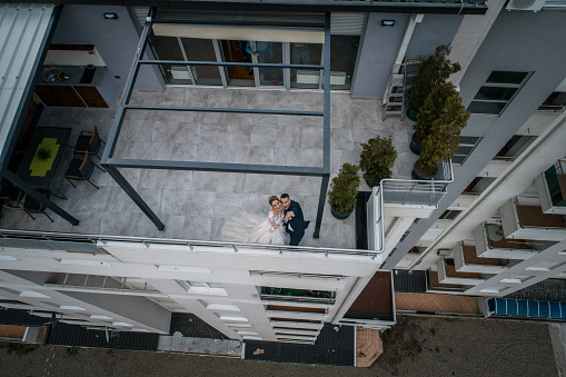 Drone shoot of wedding couple dancing on their balcony