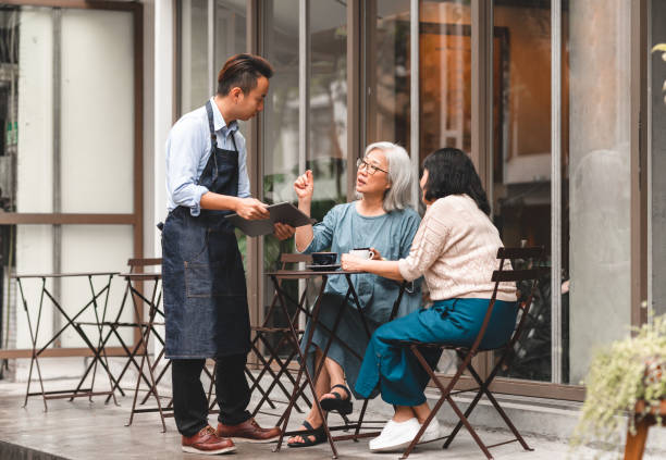 istock Senior women using contactless payment at a cafe 1149314118