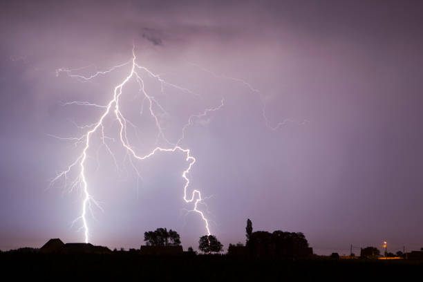 Lightning strikes Lightning over a small village in Flanders storm cloud sky dramatic sky cloud stock pictures, royalty-free photos & images