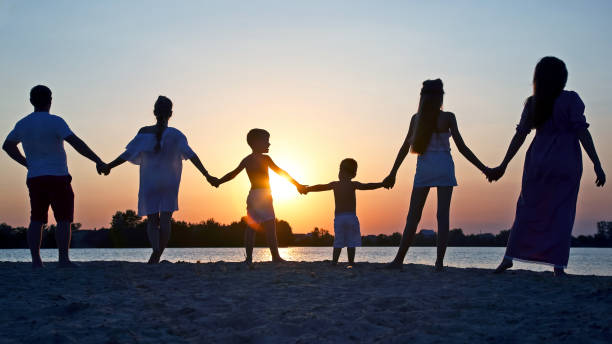 istock Silhouette of family on sunset background 1149314318