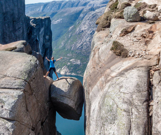 norway - a girl standing on kjerag with view on lysefjorden - rock norway courage mountain imagens e fotografias de stock