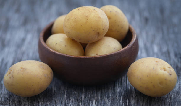 istock Fresh whole potatoes wooden bowl 1149319144