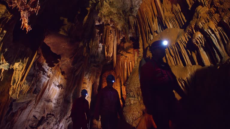 PAN Cavers walking through cave full of beautiful dripstones