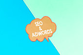 seo and adwords speech bubble isolated on pink and blue background