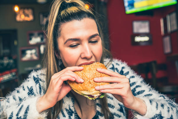 istock Woman eating burger 1149322070
