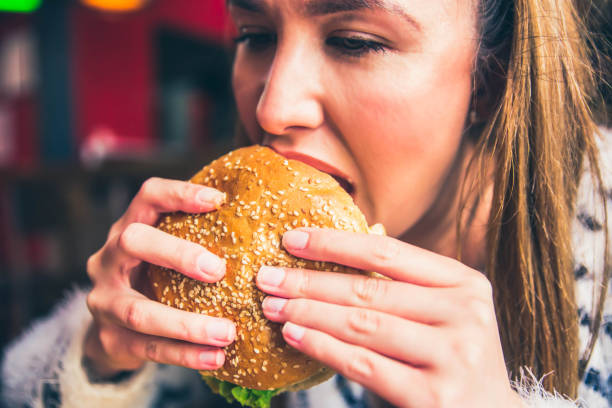 istock Woman eating a big hamburger 1149322185