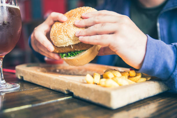 istock Tasty Burger in mans hand 1149322201