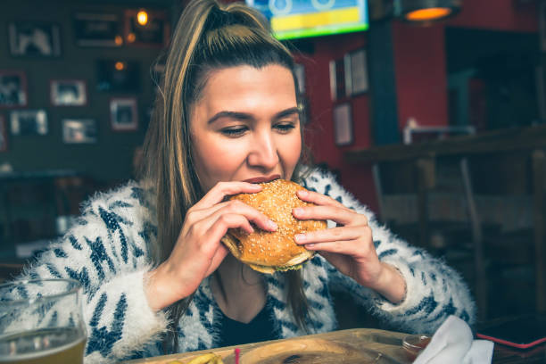 istock Girl eating a hamburger 1149322273