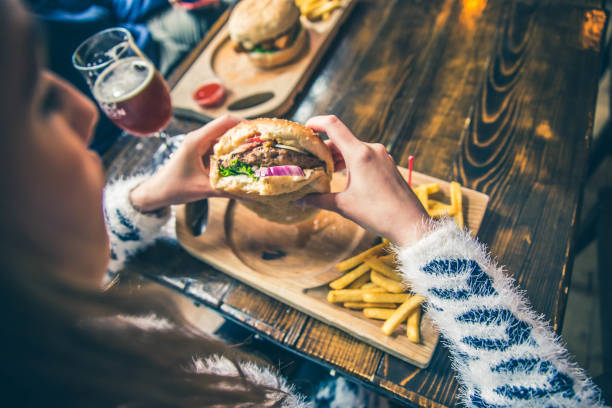 istock Burger in woman hand 1149322508