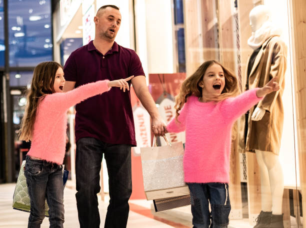 istock father is not happy in shopping mall with daughters 1149325109