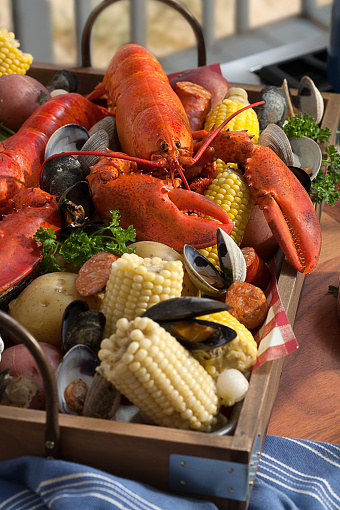 Lobster, corn and clams in a tray freshly baked