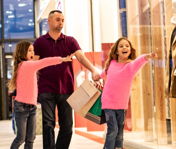 istock Father is tired in shopping with two daughters 1149325377