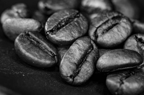 istock Brown roasted coffee beans on black background, close up, macro 1149327081