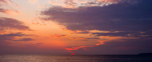 istock Amazing sea sunset on the pebble beach, the sun, waves, clouds 1149327902