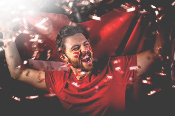 Swiss fan celebrating with the national flag Swiss fan celebrating with the national flag fan enthusiast stock pictures, royalty-free photos & images