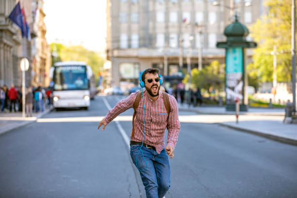 istock Young Man Walking on the City Road in a Dancing Mood 1149329652