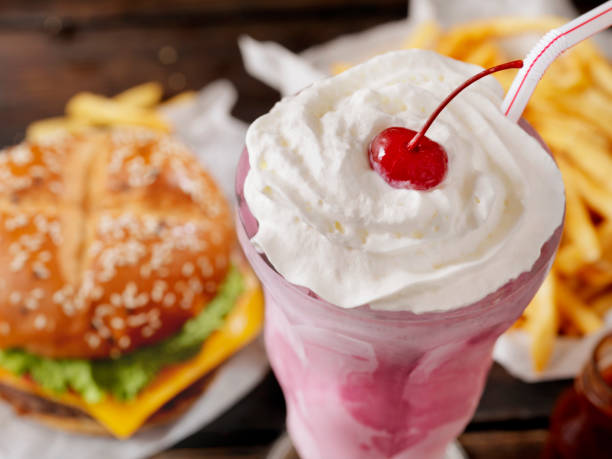 Strawberry Milkshake with a Burger and Fries Strawberry Milkshake with a Burger and Fries milkshake stock pictures, royalty-free photos & images