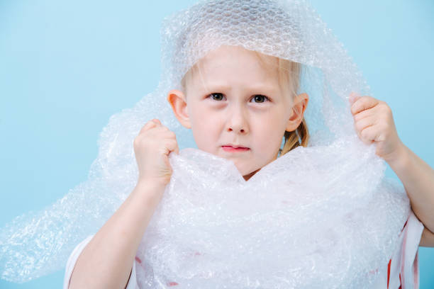 istock Little boy is dressed in bubbled wrap in protest of waste crisis 1149330661