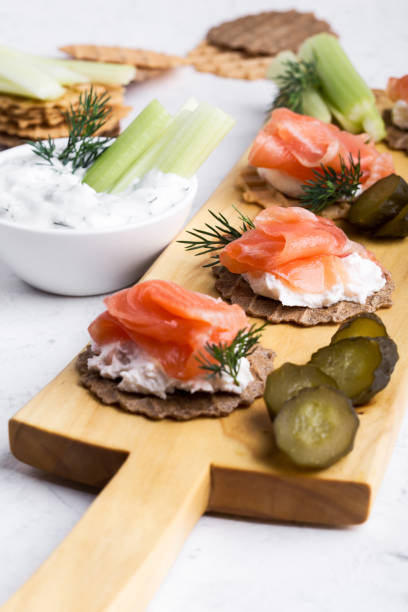 istock Appetizer with smoked salmon, yoghurt dip with dill, celery sticks and pickles 1149331942