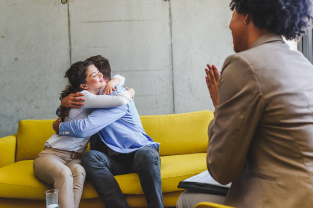 istock Young diverse married couple talking to their agent, advisor,therapist or sales representative 1149332979