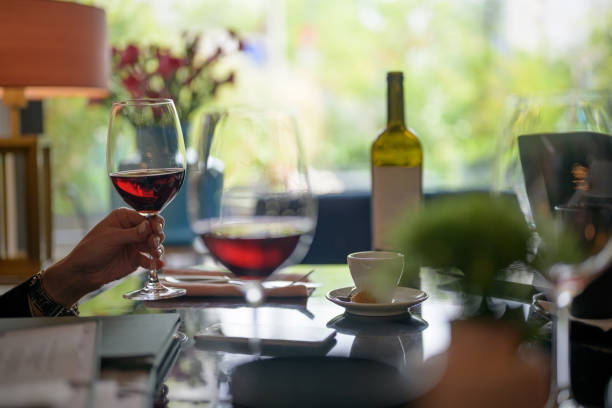 Woman with red wine during business lunch, Nikon Z7