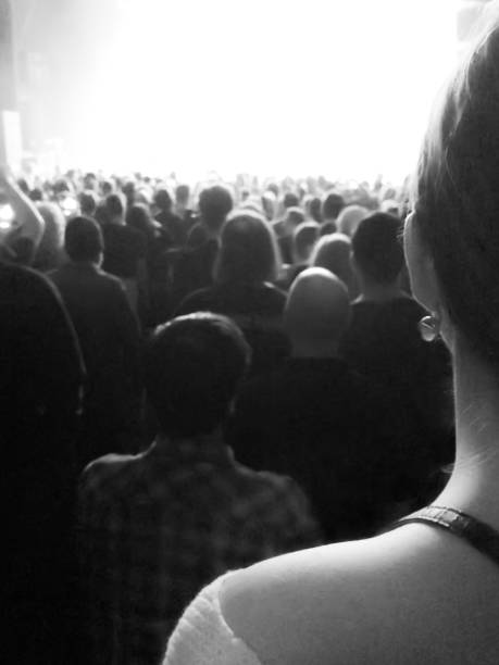 istock Woman’s shoulder, concert crowd, black and white portrait 1149333137