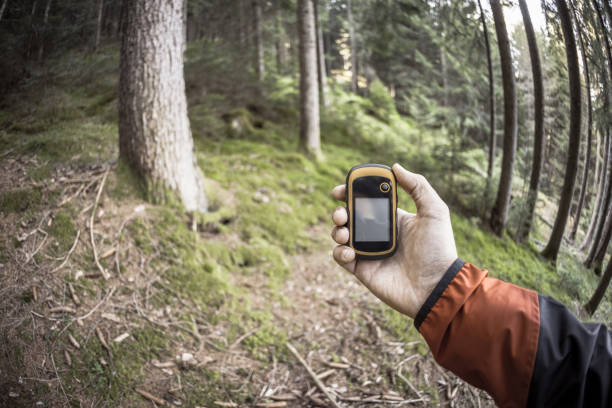 istock A trekker using gps among the forest in a cloudy day 1149335319
