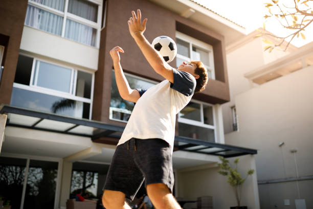 Teenage boy doing freestyle soccer tricks