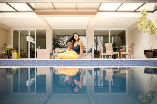istock Cute brunette girl by the pool 1149335922
