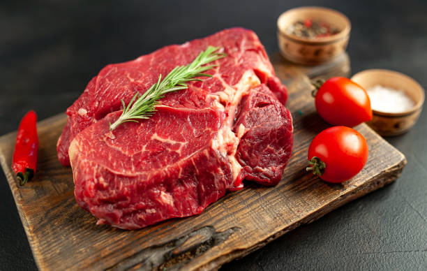 istock raw beef steak with herbs and spices on a stone background 1149337273