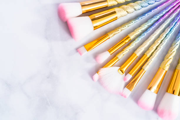 istock Unicorn color makeup brushes on a marble background. 1149337582