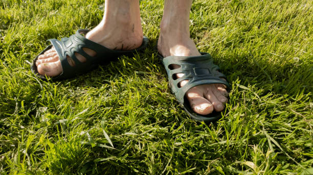 istock A man puts on a slap on the grass slow motion 1149340142
