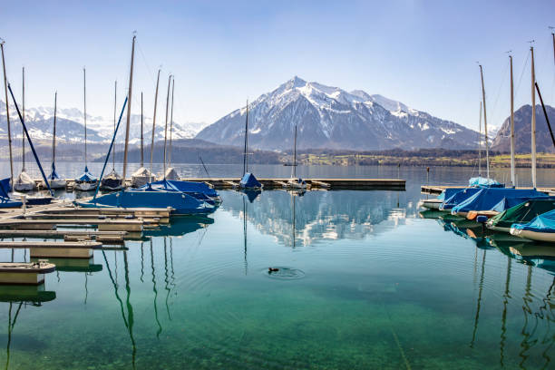 istock Boats docked at the harbor on Lake Thun with mountain reflecting 1149340825