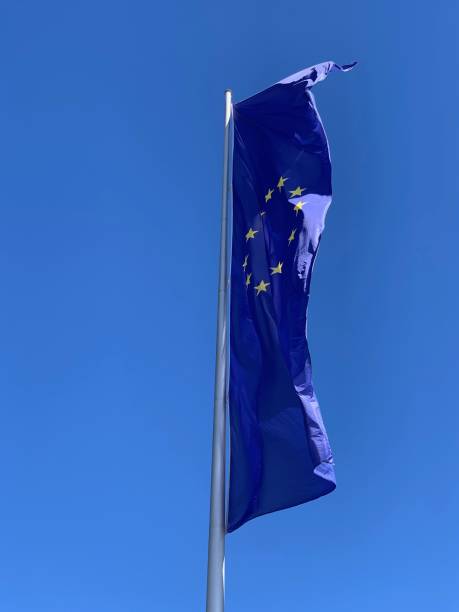 istock EU flag blowing in the wind on blue sky 1149341438