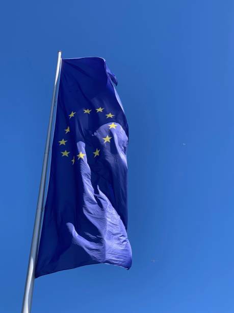 istock EU flag blowing in the wind on blue sky 1149341447