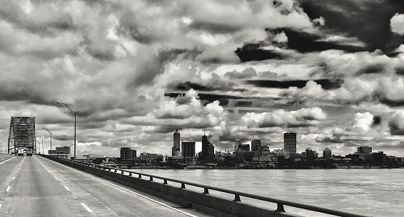 View of downtown Memphis beyond the Mississippi River, this photograph was taken in the high cab of the semi, from Marion, Arkansas, the sign on the bridge ahead welcomes you to Tennessee proper. March 1, 2018