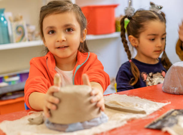 istock Cute Little Girls making Cremic 1149341893