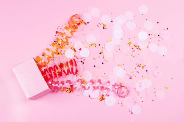 istock Box on pink background with multicolored serpantine and confetti. 1149342707
