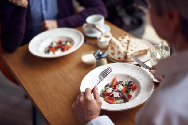 istock Two plates with salad on table in cafe 1149343864