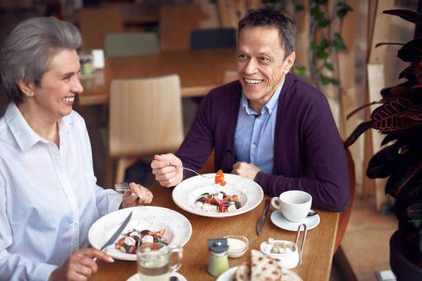 istock Middle aged man and lady having dinner in cafe 1149343866